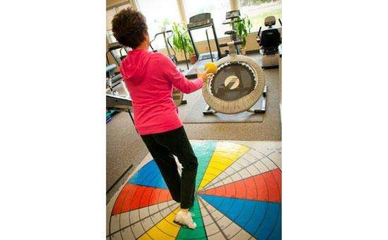 Woman throwing  ball at trampoline