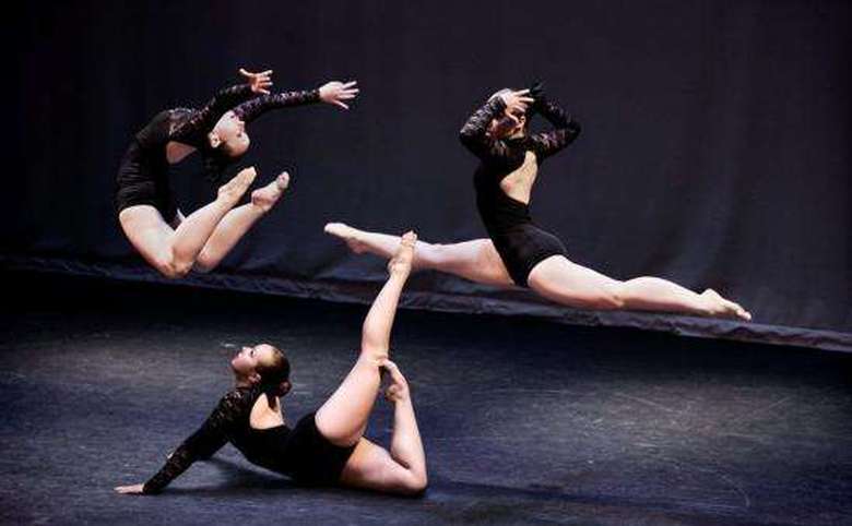 Three girls, tow in the air and one on the ground