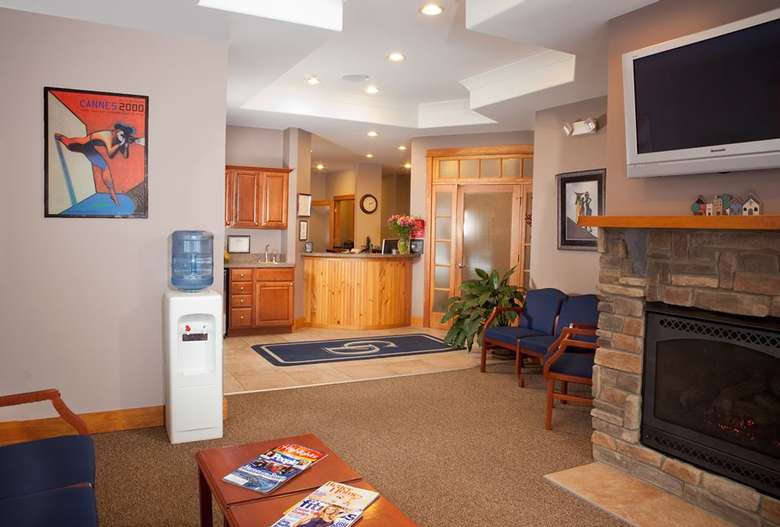 a dentist office with chairs and a tv