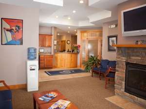 a dentist office with chairs and a tv