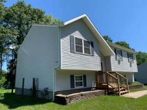 house with wooden stairs leading to door