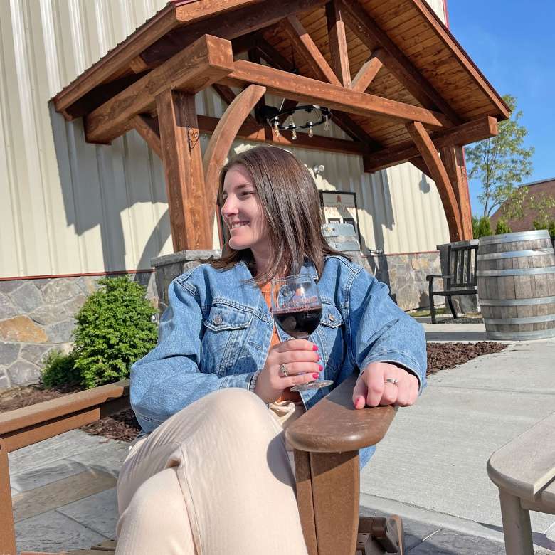 woman on patio with glass of wine