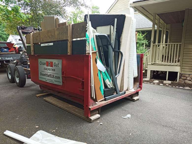 red dumpster filled with house junk Saratoga