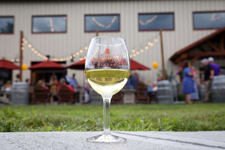 Wine glass in front of the Queensbury Tasting Room
