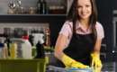 a woman with dish gloves cleaning a kitchen countertop