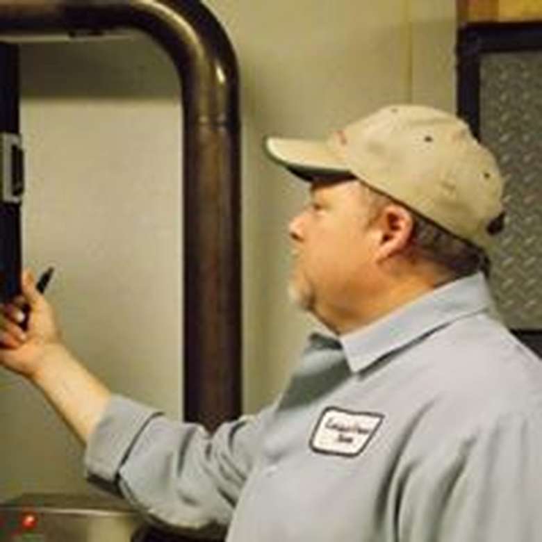 man checking a piece of machinery