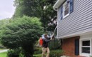 man doing pest control on a house