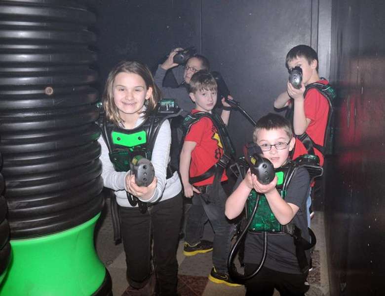 kids posing with laser tag guns