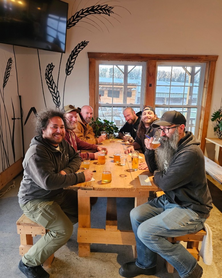 group of people seated inside a brewery