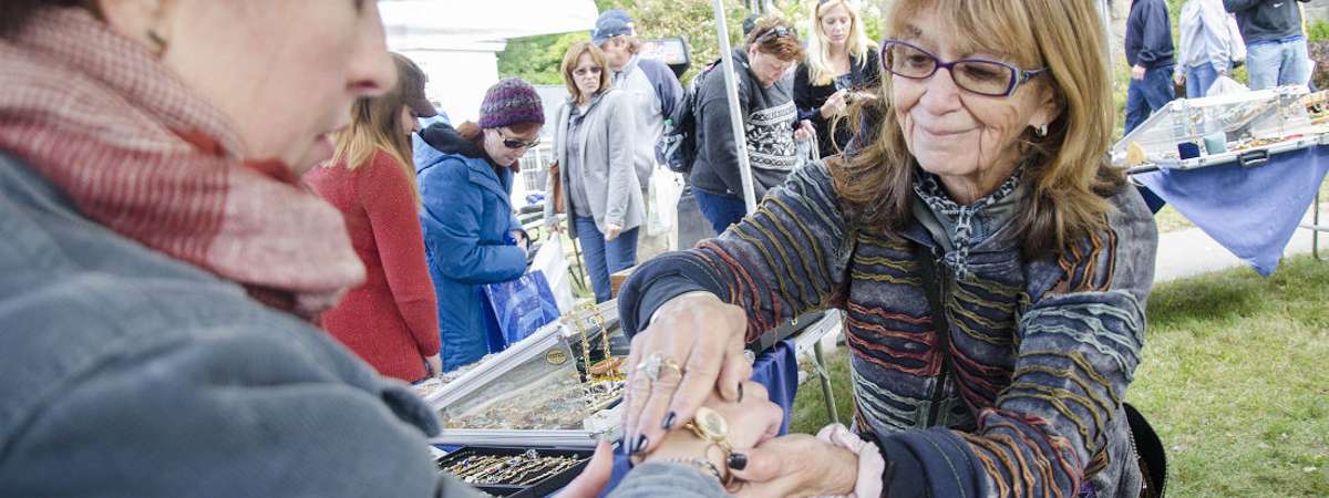 woman helping woman with bracelet