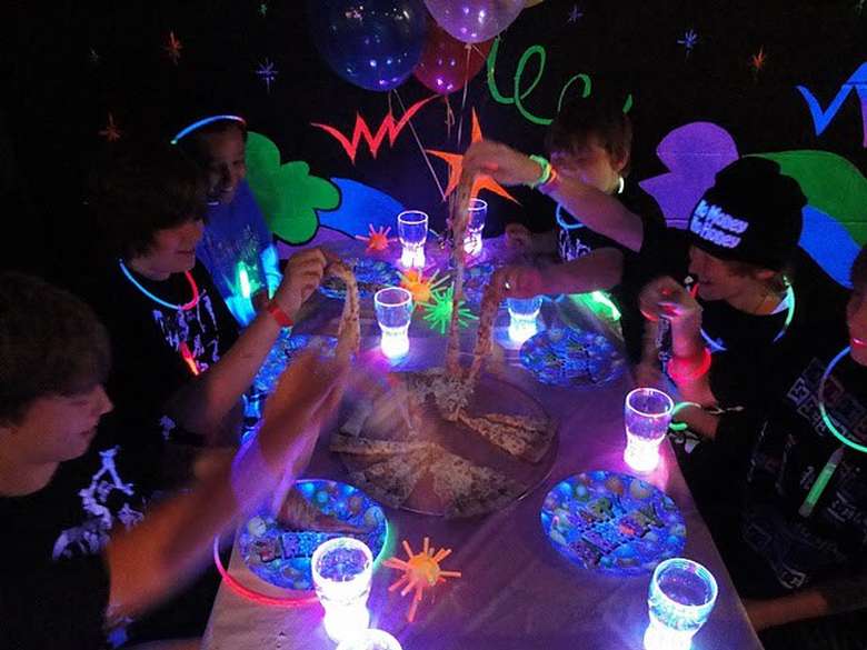 a birthday partying happening in blacklights