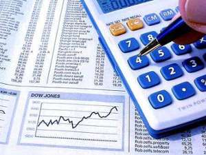 a pen tapping at a calculator, and there is a sheet of paper underneath