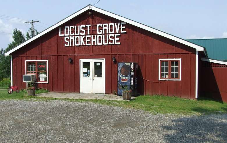 exterior of red barn with locust grove smokehouse in white letters