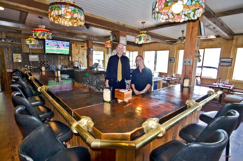 Employees standing behind bar