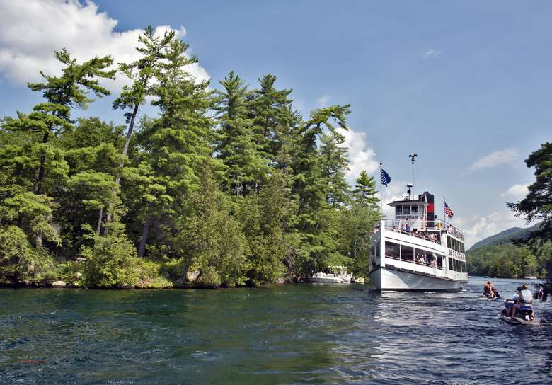 mohican steamboat driving past islands on lake george