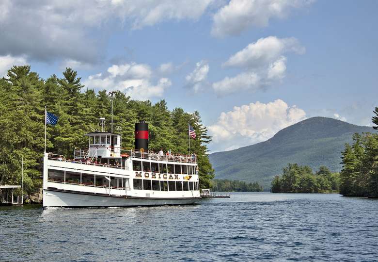 the mohican cruise ship driving past islands on lake george