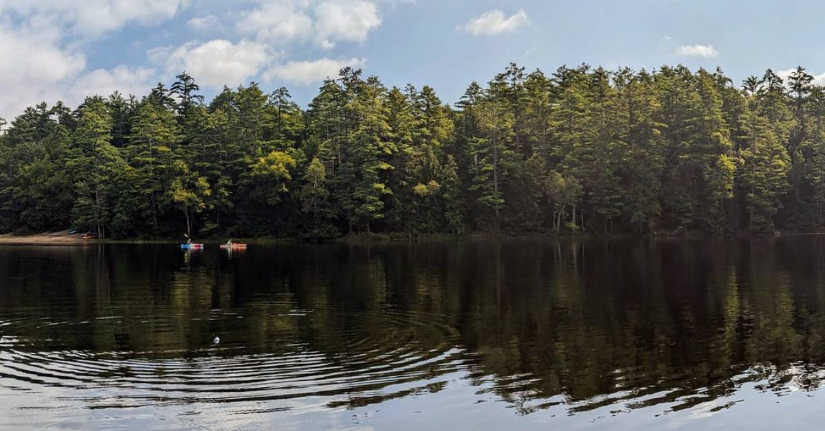 people kayaking in fourth lake at luzerne state campground