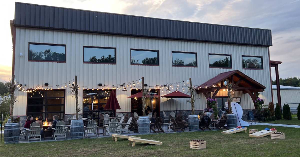 exterior of a winery building with chairs and seating outdoors
