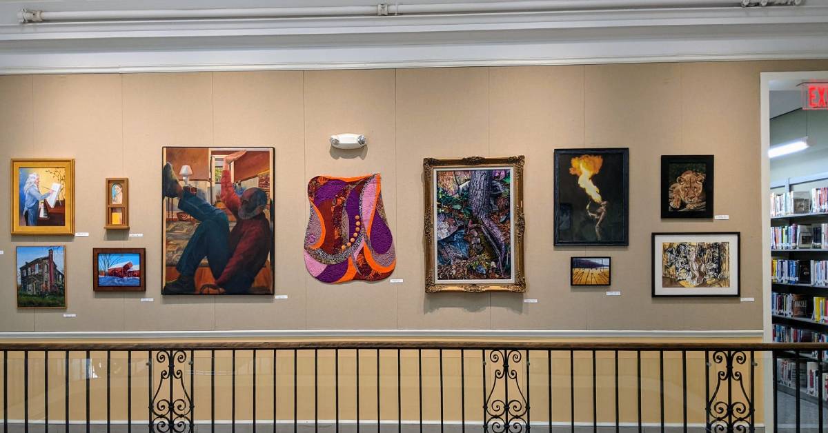 paintings hang in a library