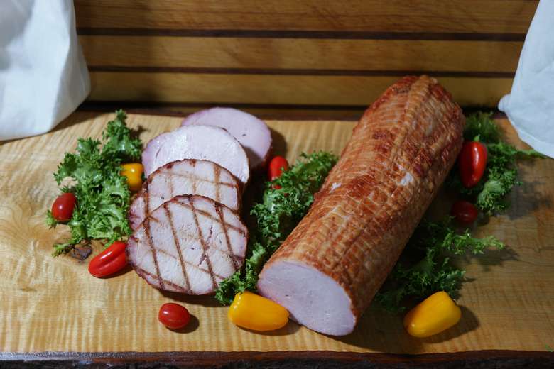 smoked meat on a green garnish