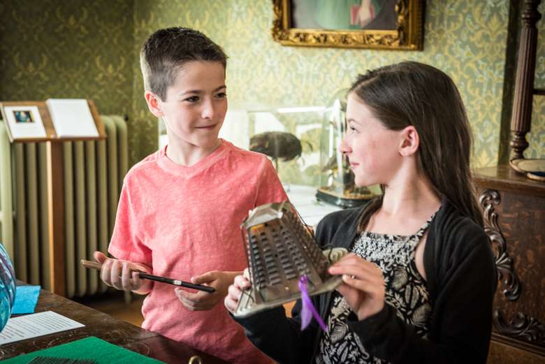 Children exploring hands-on items in the Everyday Hometown Life exhibit