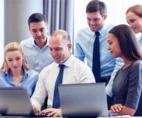 young businesspeople around a computer
