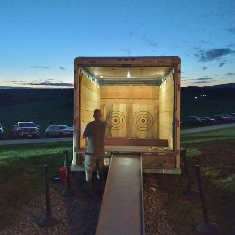 person axe throwing in a truck