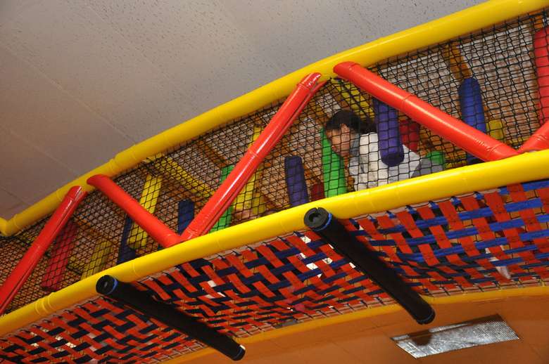 a kid playing in the indoor playground