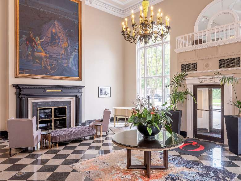 Lobby of Hotel with Fireplace, Piano and Chandelier