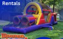 Inflatable obstacle course rental set up outdoors