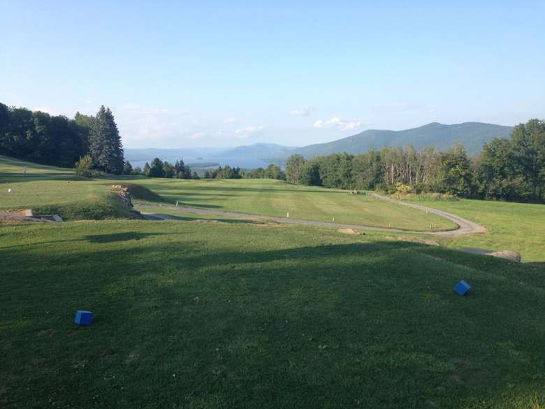 View of golf course with Lake George and mountains in the background