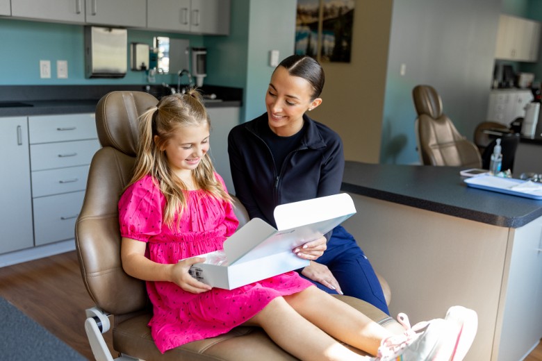 orthodontist with young girl