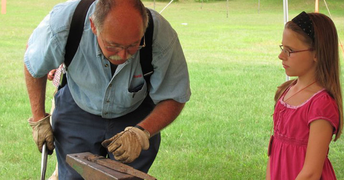 man teaches little girl woodworking