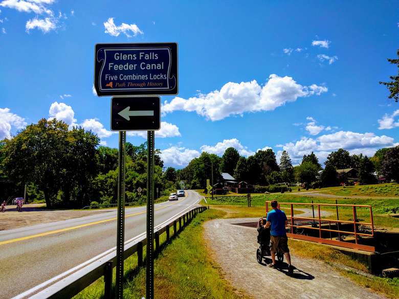 Feeder Canal trail sign, person walking with stroller