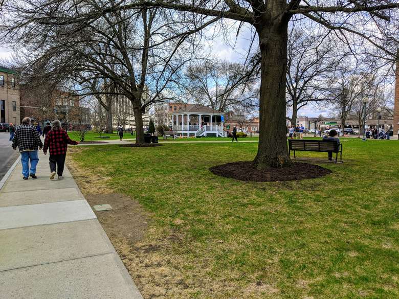 Photo credit: Alan Nudi people walking around park, trees, benches, gazebo