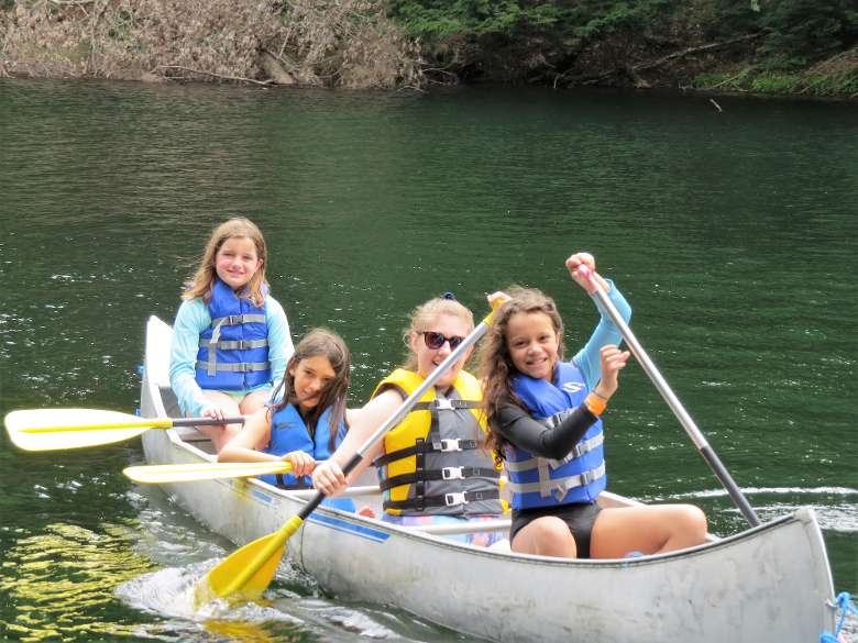 smiling group of campers in a canoe