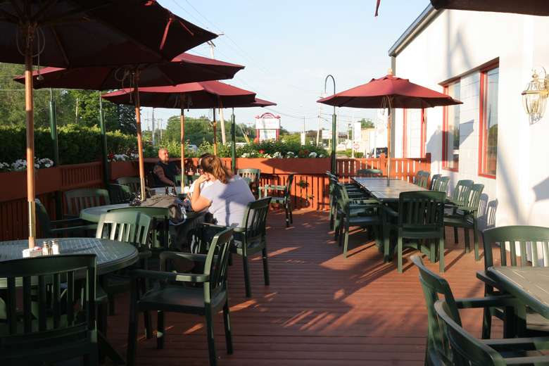 On warm days, dine out on the patio. outdoor patio seating area with umbrellas at o'tooles