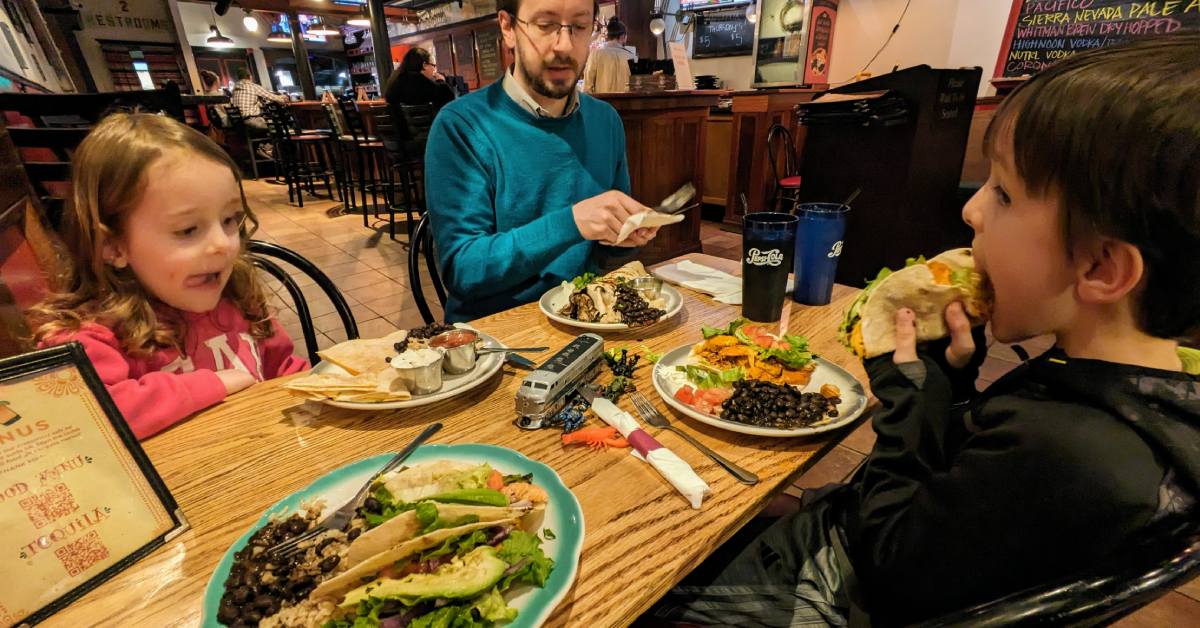 dad with kids eating at raul's mexican restaurant in glens falls