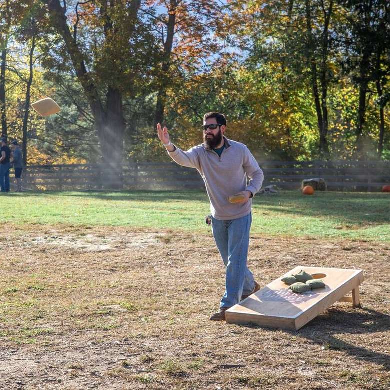man playing corn hole