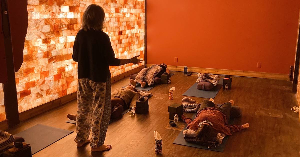 women in salt cave taking a yoga class