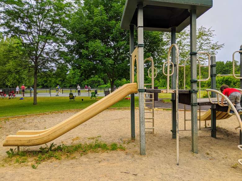 playground, people playing pickleball in the background