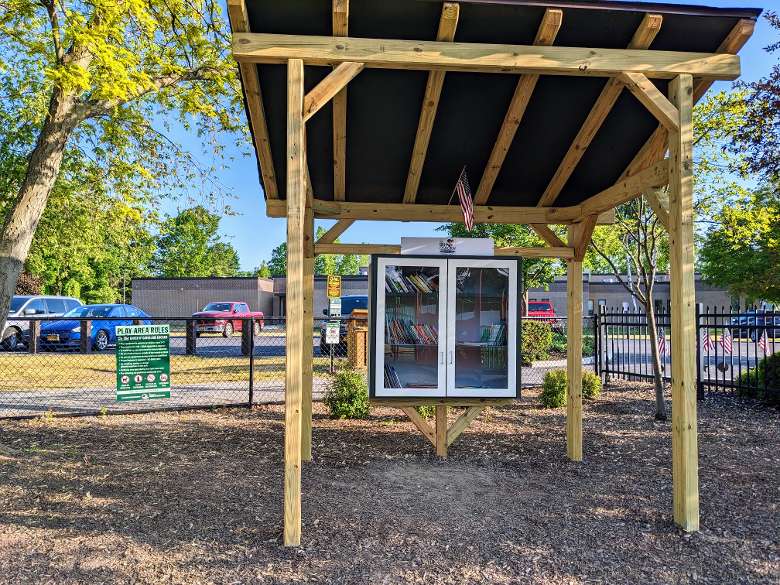 little book library with wooden structure around it