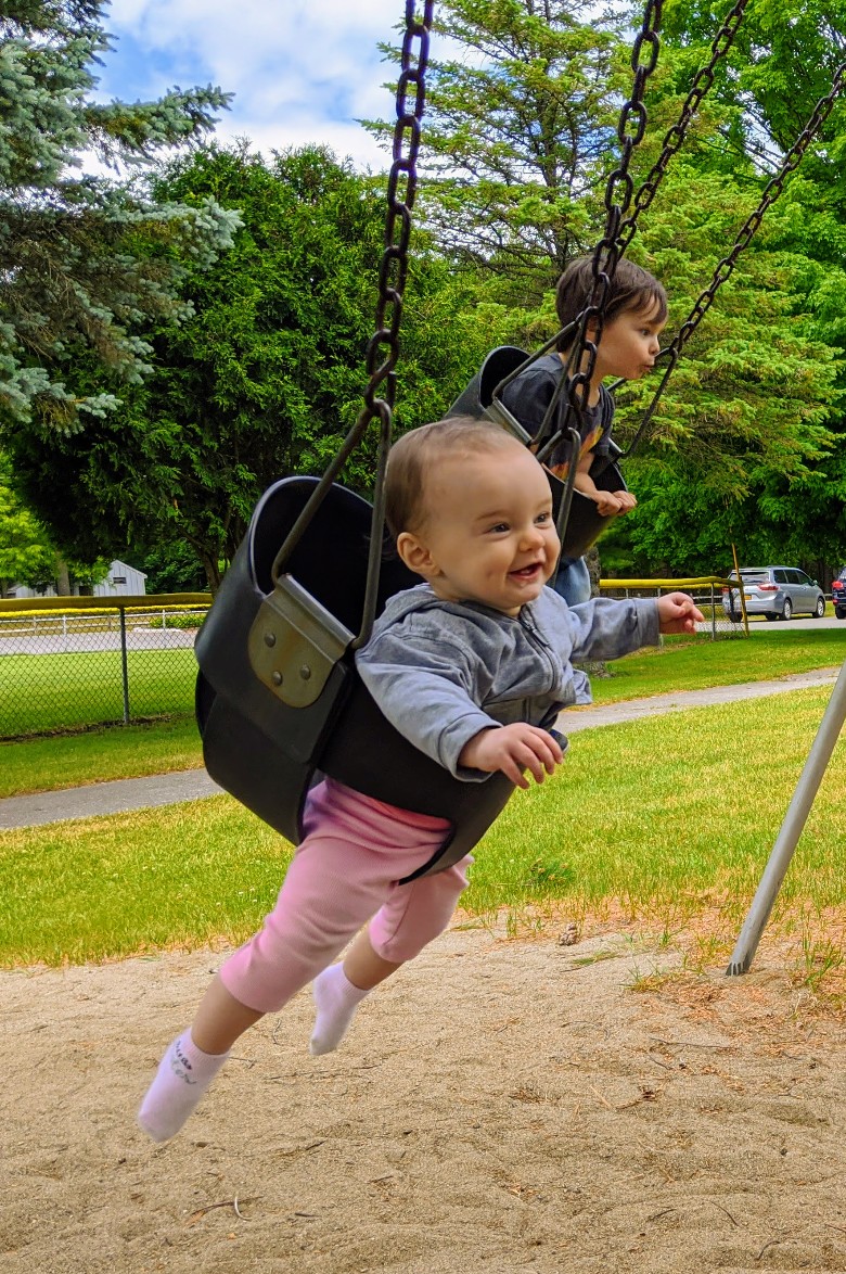baby and kid on swings