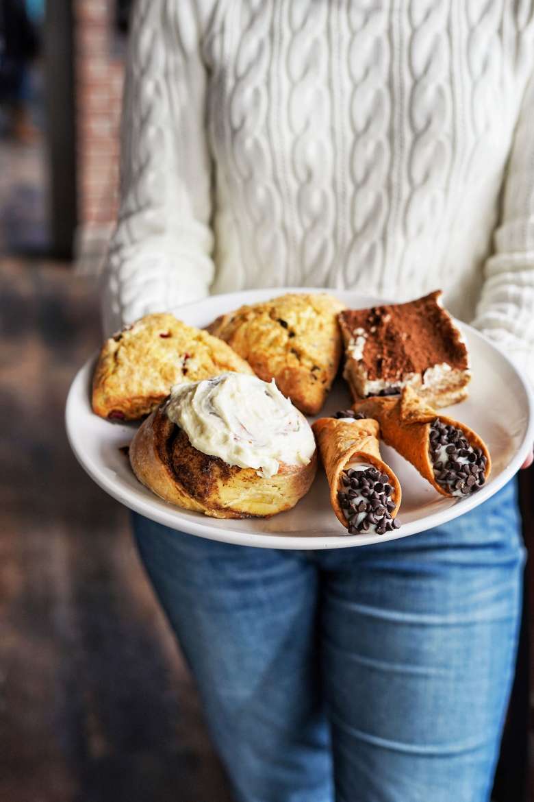 baked items on a plate being carried