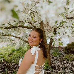 woman smiling with flowers in background