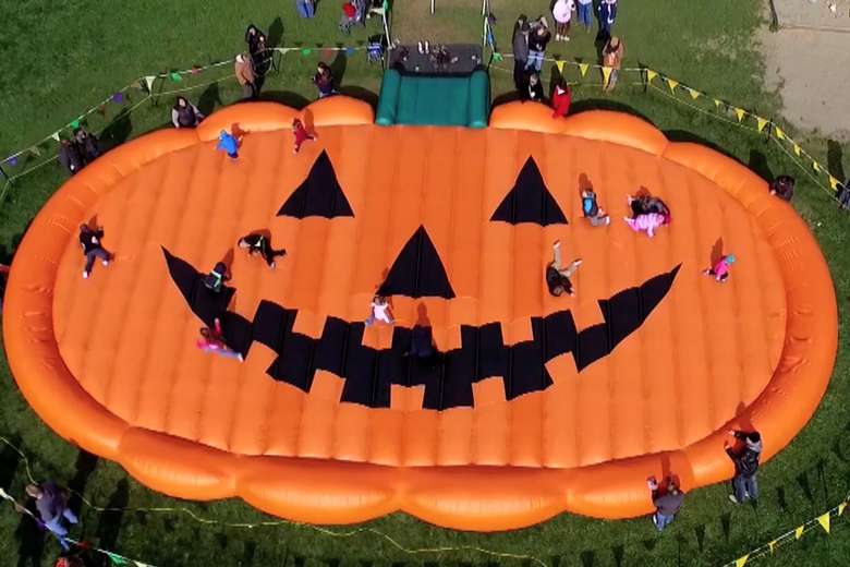aerial view of a jack-o-lantern-shaped bounce pad