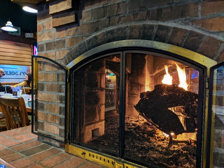 The fireplace in the center of the restaurant keeps everyone warm on chilly days. fireplace