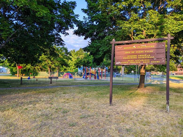 sign in park about summer program, picnicking, basketball, play apparatus, group shelter, restrooms