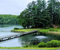 water with bridge and fountain at a queensbury golf course