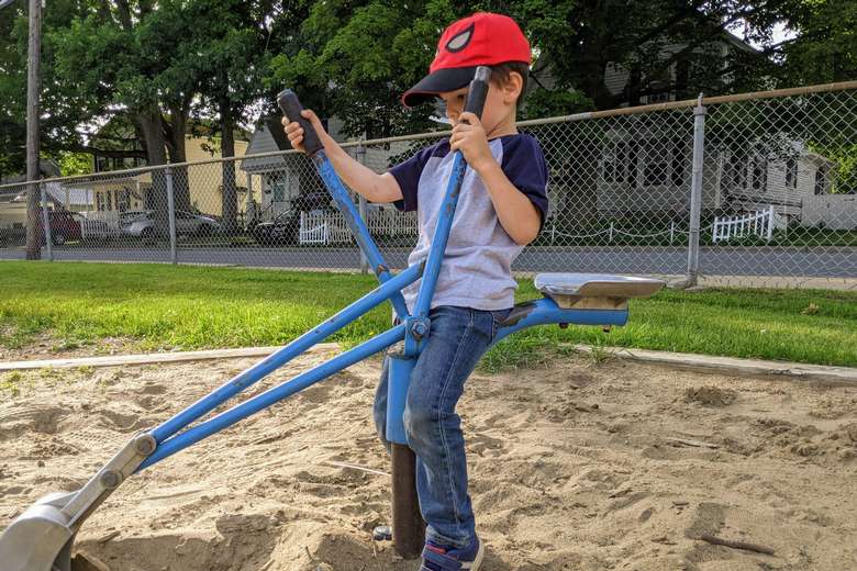 boy plays with digger equipment